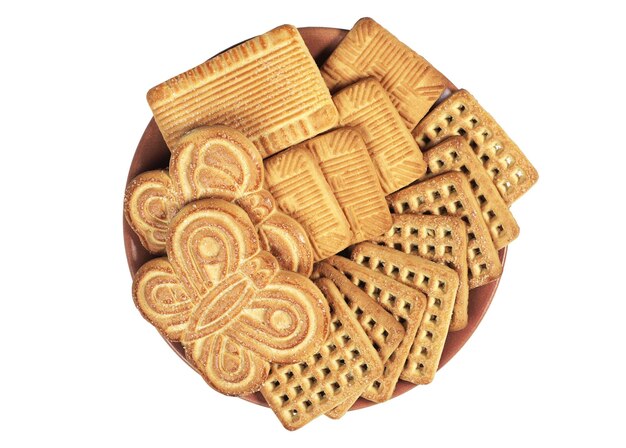 Plate with different sweet cookies isolated on white background, top view