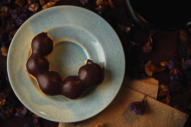 A plate with a doughnut on it and a napkin on the table.