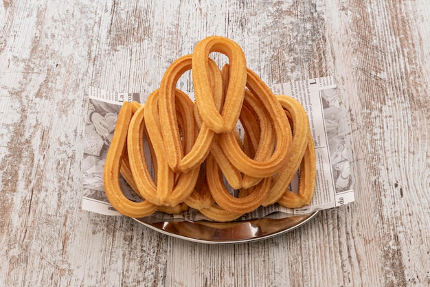 Plate with a dozen churros typical of a Spanish breakfast