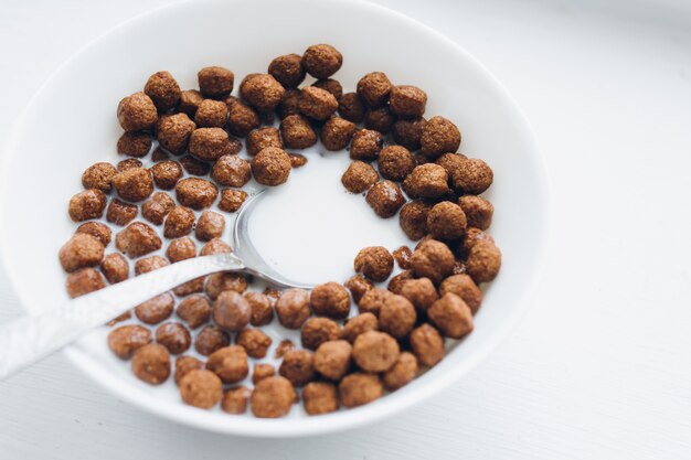 Plate with a dry Breakfast of chocolate balls with milk