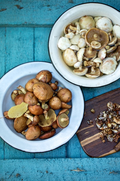 Plate with forest mushrooms on a wooden table