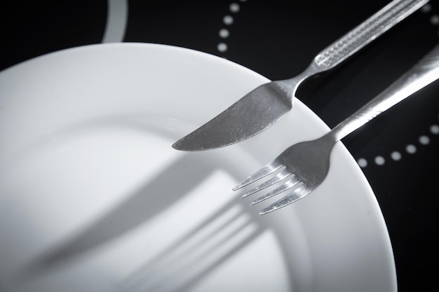 Plate with a fork and knife on the kitchen table