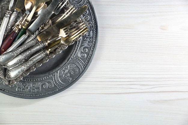 A plate with forks on it on a wooden table