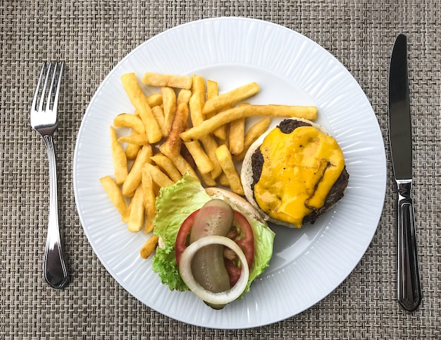 Plate with French fries and a hamburger