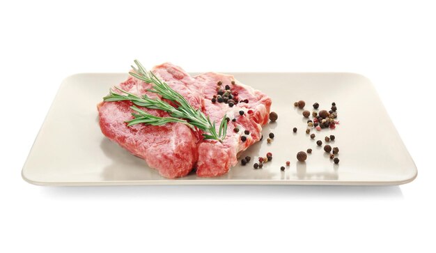 Plate with fresh raw meat isolated on white