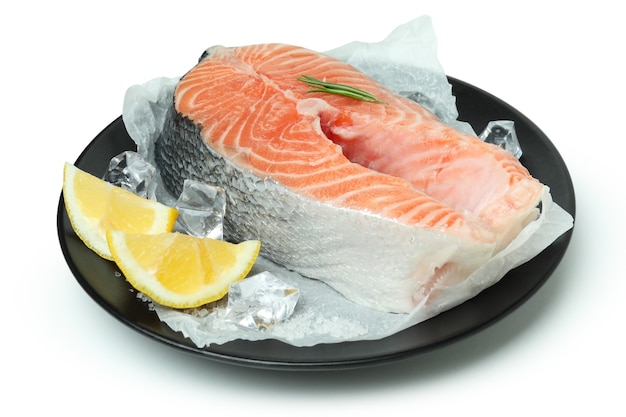 Plate with fresh raw salmon isolated on white background