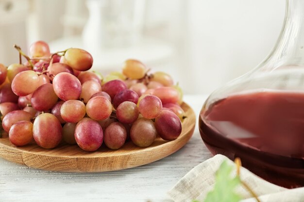 Plate with fresh ripe grapes on table