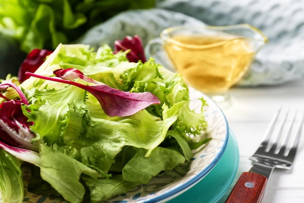 Plate with fresh salad on table closeup