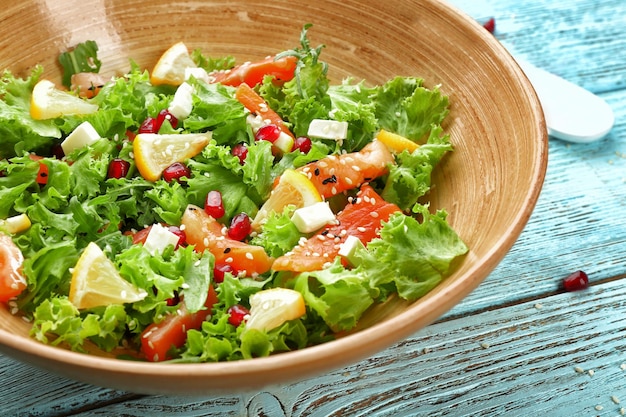 Plate with fresh salmon salad on table closeup