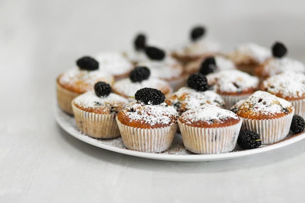 Plate with freshly baked sweet muffins. Sweet pastries, recipes, cooking