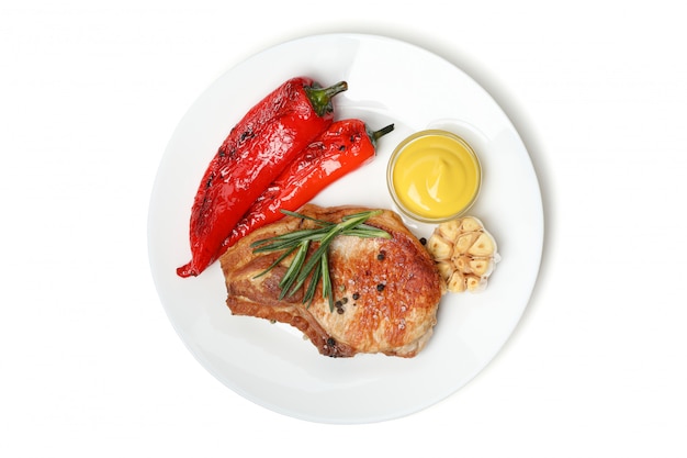 Plate with fried steaks and vegetables isolated