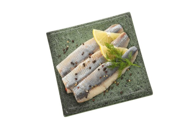 Plate with herring fish slices and spices isolated on white surface