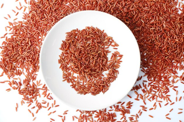 Plate with jasmine brown rice on white background