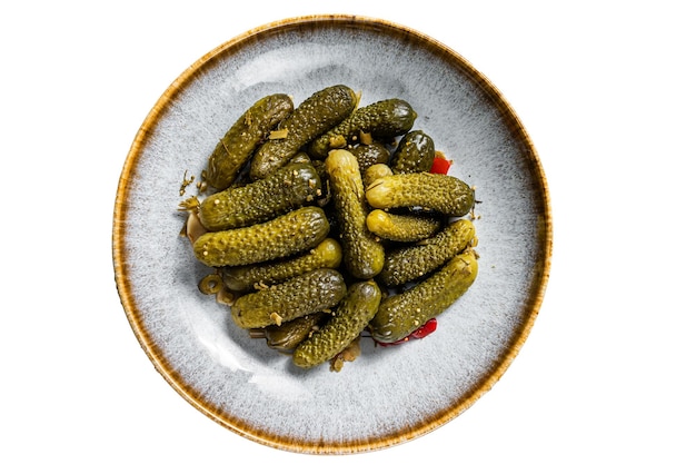 Plate with Pickled gherkins cucumbers on wooden board Isolated on white background