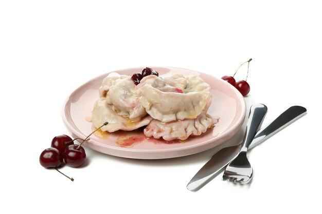 Plate with pierogi with cherry isolated on white background