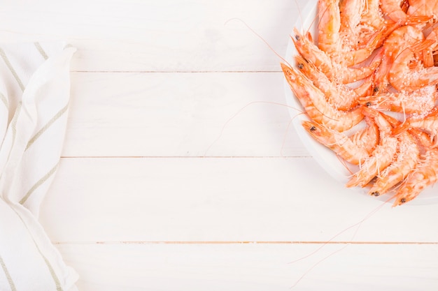 Plate with prawn on kitchen table