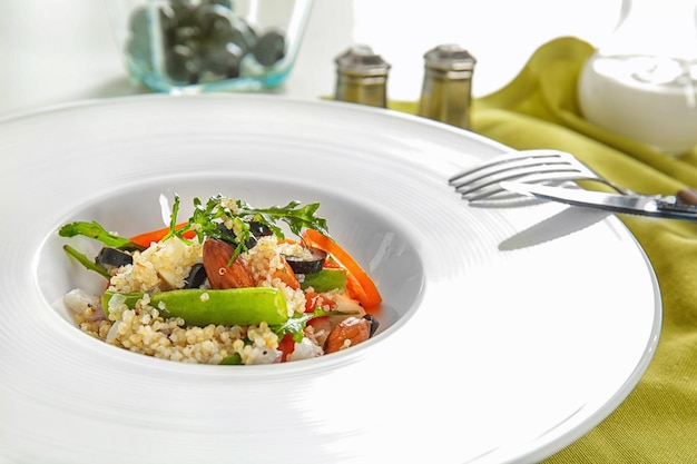 Plate with quinoa salad on table closeup