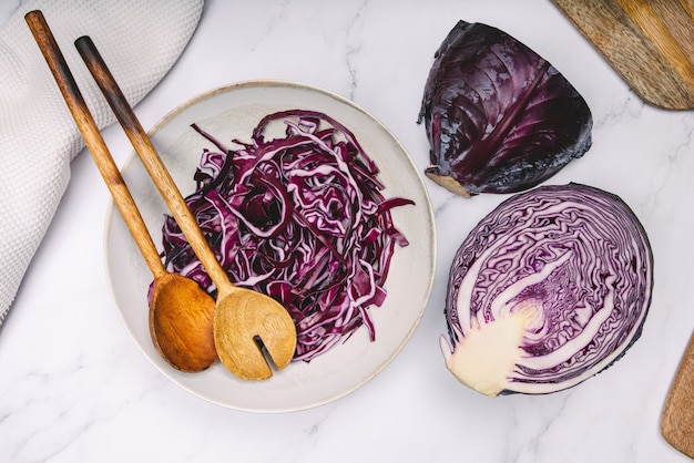 Plate with red cabbage cut with wooden spoons