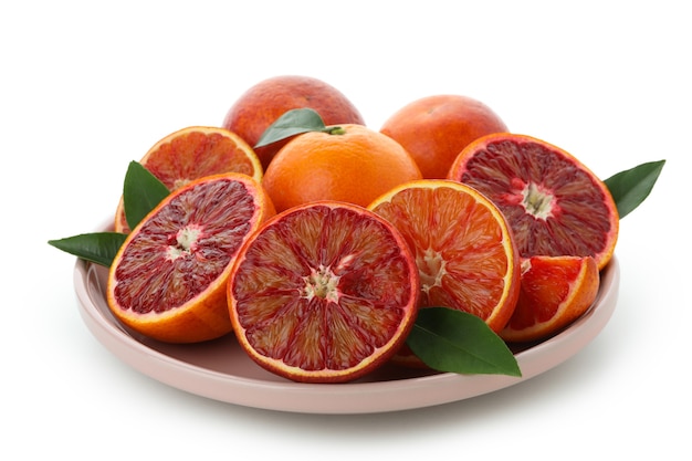 Plate with red oranges isolated on white