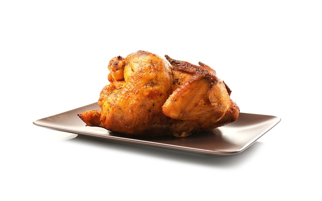 Plate with roasted beer can chicken on white background