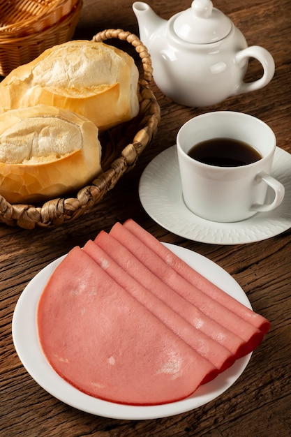 Plate with sliced mortadella on the table