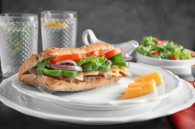 Plate with steak sandwich on table