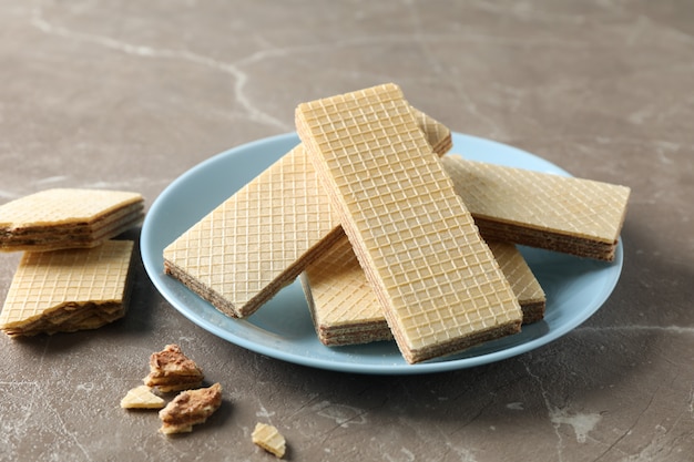 Plate with sweet wafers on grey