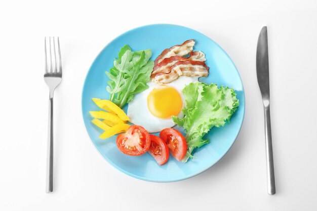 Plate with tasty egg for breakfast on white background