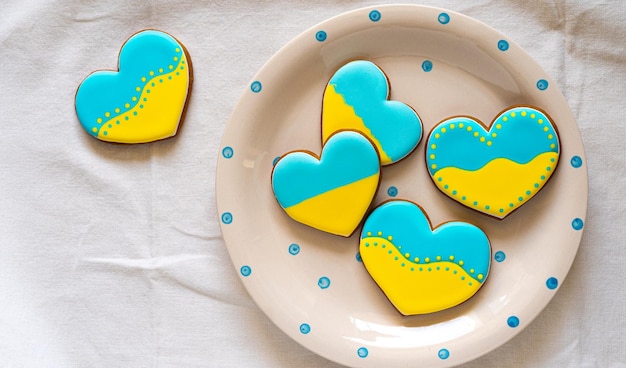 Plate with tasty gingerbread cookies in ukrainian flag colors