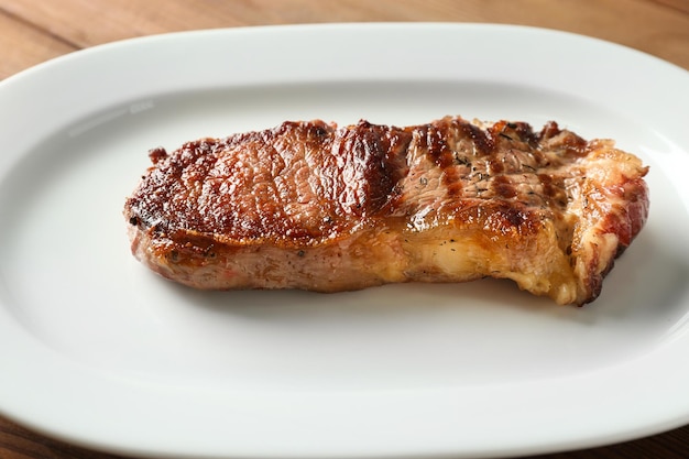 Plate with tasty steak closeup