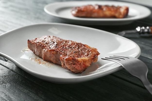 Plate with tasty steak closeup