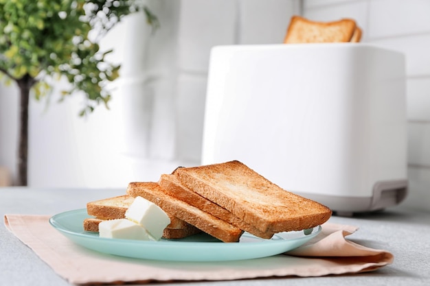 Photo plate with toasted bread and butter on table