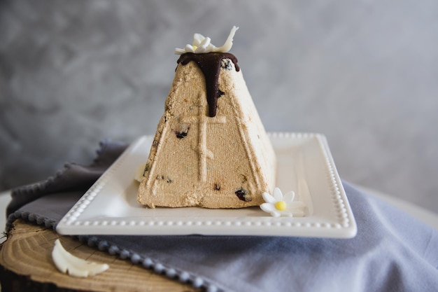 Plate with traditional Easter curd dessert on table