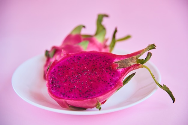 Plate with tropical exotic Dragon fruit pitaya nutrition ripe raw asian fruits delicious