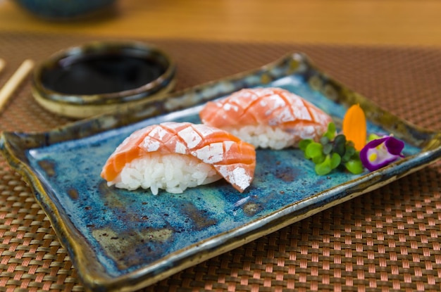 Plate with two elegant nigiri sushi nigirizushi with diamondshaped knife cuts