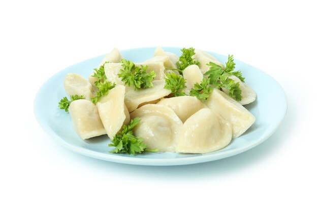 Plate with vareniki or pierogi isolated on white surface