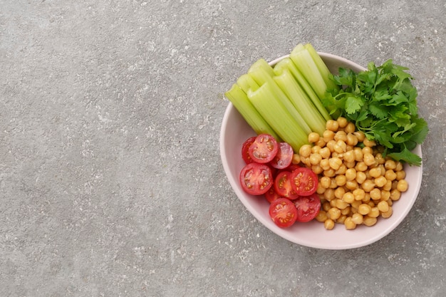 Plate with various raw vegetables and boiled chickpeas