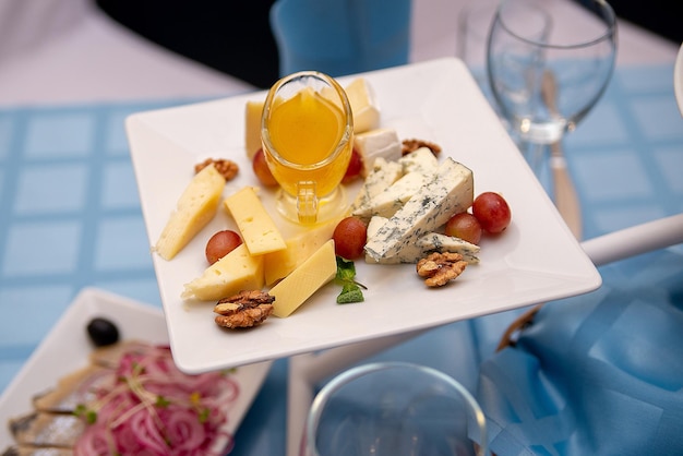 Plates of cold cheese appetizers on a served table wedding banquet celebration