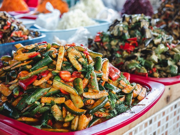 Plates and trays with pickles lying in the market