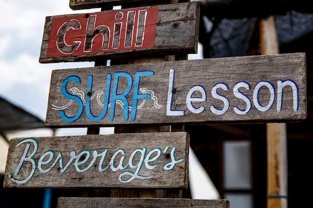 Plates with different offers services on the beach.