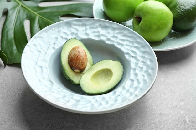 Plates with fruits on grey background