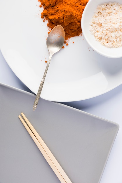 Plates with spices and plate with chopsticks