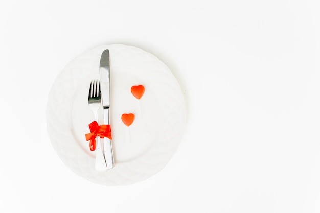 Plating contains fork and knife near lollipops