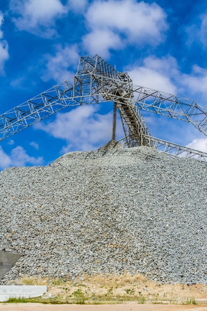 Platinum mining and processing of ore, piles of ore rock being moved and stored