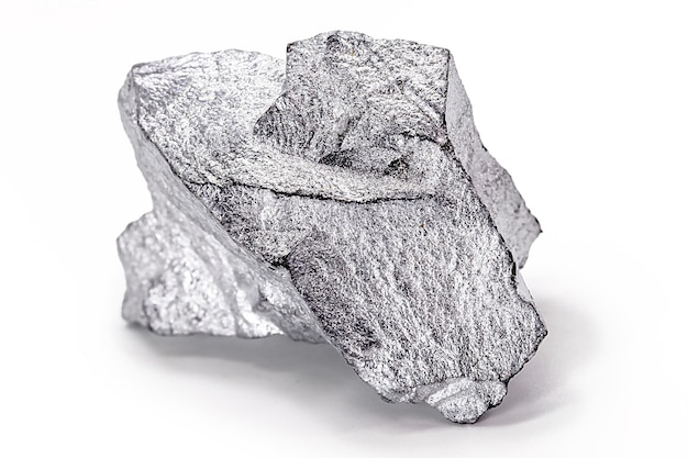 Platinum nugget on white isolated background valuable stone white gold macro photography