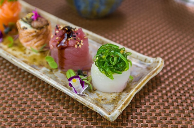 Platter decorated with different flavors of elegant gunkan sushi