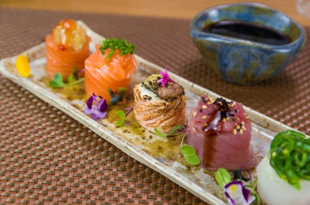 Platter decorated with different flavors of elegant gunkan sushi