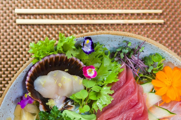 Platter decorated with different flavors of elegant sashimi sushi Selective focus