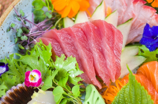 Piatto decorato con diversi gusti di elegante sashimi sushi messa a fuoco selettiva