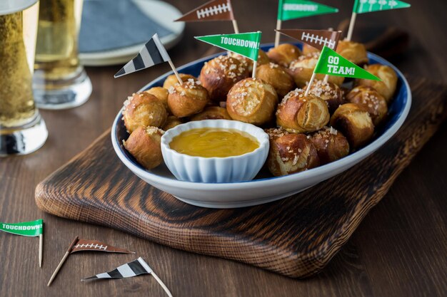 A platter of homemade pretzel bites with beer ready for a Super Bowl party